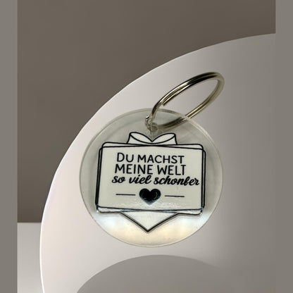 Schlüsselanhänger "Du machst meine Welt so viel schöner" – Liebevolles Geschenk aus klarem Acryl Schlüsselanhänger Das Glückswerk